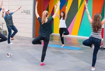 A Nasher intern leads yoga in the Great Hall for other students.