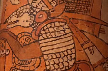 Very close up image of the face of an animal that is painted onto a glazed piece of Mesoamerican pottery from the Art of the Americas Gallery.