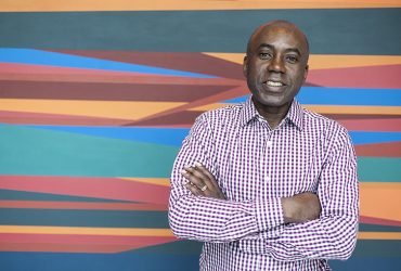 Odili Donald Odita poses in front of his work