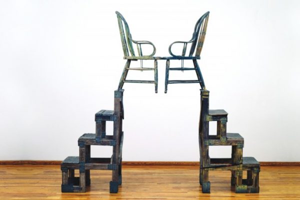 Robert Rauschenberg, The Ancient Incident (Kabal American Zephyr), 1981. Wood-and-metal stands and wood chairs, 86 1/2 x 92 x 20 inches (219.7 x 233.7 x 50.8 cm). Robert Rauschenberg Foundation, New York, New York. © Robert Rauschenberg Foundation / Licensed by VAGA, New York, New York.