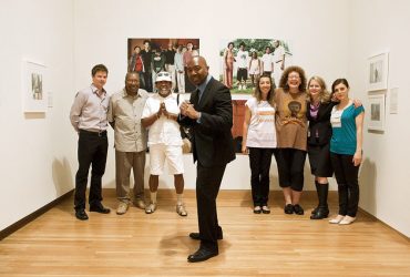 On the occasion of Becoming: Photographs from the Wedge Collection, collector Dr. Kenneth Montague (front) visits the gallery with (from left) Chief Curator Trevor Schoonmaker; Spurgeon Montague, the collector’s father; artist Barkley L. Hendricks; Reneé Cagnina Haynes, Exhibitions and Publications Manager; Susan Hendricks, the artist’s wife; Wendy Hower, Director of Engagement and Marketing, and Maria Kanellopoulos, Wedge Collection assistant. Photo by J Caldwell.