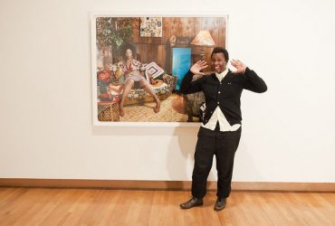 Artist Mickalene Thomas poses in front of her work. Photo by J Caldwell.