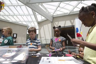 Young visitors make mobiles and stabiles inspired by Calder at a Family Day event. Photo by J Caldwell.