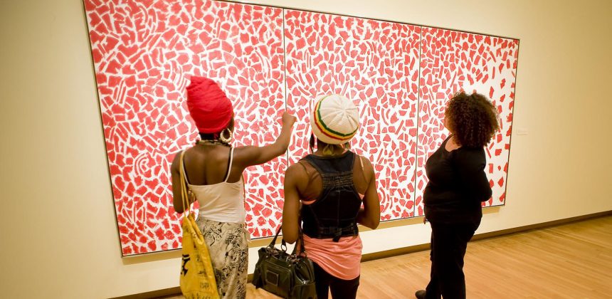 Visitors take in a work by contemporary abstractionist Alma Thomas. Photo by J Caldwell.