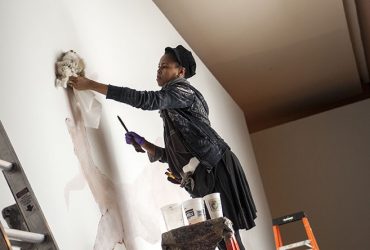 Wangechi Mutu works on a monumental entrance wall drawing, Once upon a time she said, I’m not afraid and her enemies became afraid of her The End. Photo by J Caldwell.