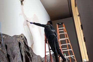 Wangechi Mutu works on a monumental entrance wall drawing, Once upon a time she said, I’m not afraid and her enemies became afraid of her The End. Photo by J Caldwell.
