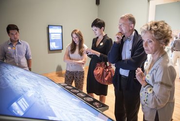 Visitors' faces light up from the interactive displays that tell stories of Jacopo de’ Barbari’s View of 1500.