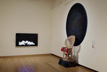 Installation view of Area 919 exhibition, featuring a sculpture (right) by André Leon Gray, What Does Revolution Sound Like?, created in 2010, and a video (left) by Hong-An Truong, Explosions in the Sky (Điện Biên Phủ 1954). Photo by Peter Paul Geoffrion.