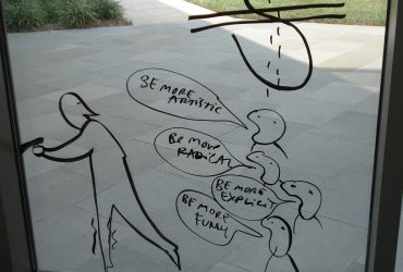 Dan Perjovschi creates humorous drawings on the museum’s exterior windows using current events and situations special to Duke as his inspiration. Photo by Duke Photography.
