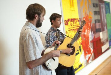 Musicians play live music in front of a work by Robert Rauschenberg during a Reflections tour. Photo by J Caldwell.