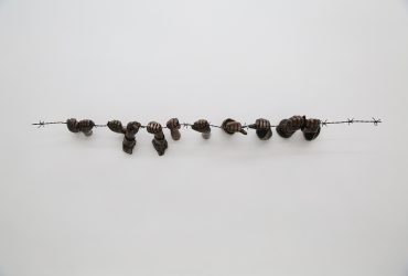 For the Punctum Series, Hank Willis Thomas collected material from 20th-century German publications and archives. He selected details from photographs of the Holocaust and the collapse of the Berlin Wall, removing the imagery from its original context and shaping it into three-dimensions. In this sculpture, several sets of anonymous hands grab onto a string of barbed-wire fencing. The wire might call to mind concentration camps in Germany during World War II, or even the increasing incarceration of people of color in the United States. By presenting only a small element of a larger scene, Thomas allows viewers to provide their own narratives and to engage in the process of identity formation. The artist’s use of bronze, an ancient medium, lends physical and symbolic gravity to the subject while firmly placing contemporary social injustices within the history of art.