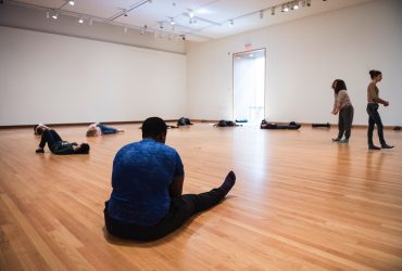 Participants of Parliament stand, walk, lie down and otherwise navigate an empty gallery space, in silence, for six hours a day, over the course of four days, at the Nasher Museum. Photo by J Caldwell.
