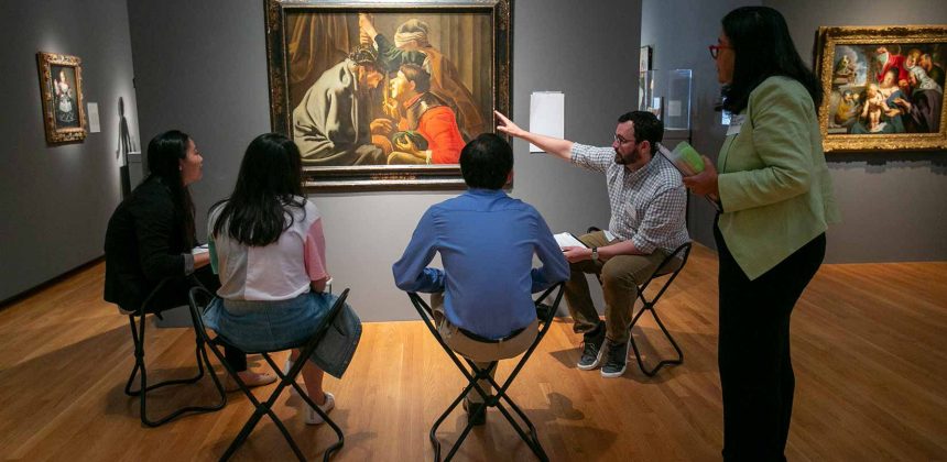 "Reimagining" students examine paintings with dermatologist Lynn McKinley-Grant and Ryan Helsel, Nasher Museum educator. Photo by Megan Mendenhall.