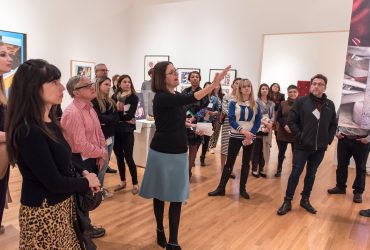 Guest Curator and Duke Professor Esther Gabara leads a media preview tour through Pop América. Photo by J Caldwell.