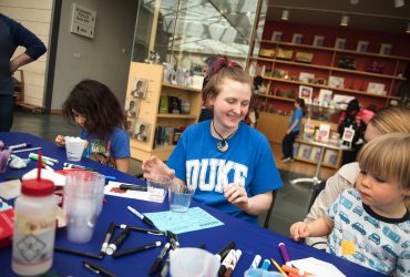 A Duke student helps out on Family Day