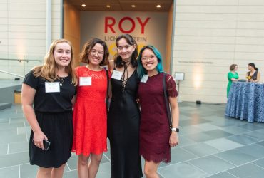 Duke Students Ruth Player, Eliza Henne, Abby Johnson and Rachel Johnson pose at the entrance wall of Roy Lichtenstein: History in the Making, 1948 — 1960