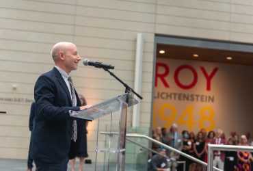 Co-curator Marshall N. Price, PhD addresses the crowd at the Director's Preview event for Roy Lichtenstein: History in the Making, 1948 — 1960