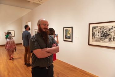 A visitor takes in early work by Roy Lichtenstein