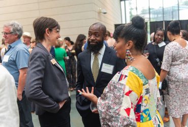 Thomas RaShad Easley (center) enjoys chatting with friends at the Director's Preview event