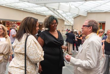 Frank Konhaus and Mavis Gragg (middle) enjoy a moment at the Director's Preview event