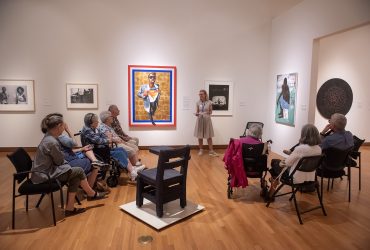 Gallery Guide Mindy Solie leads Reflections Program members on a tour of By dawn's early light