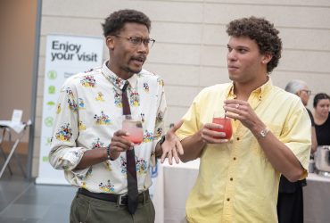 Postdoctoral Associate in History, Aaron Colston, chat with his friend in the Great Hall.