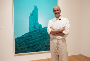 Artist David Benjamin Sherry with his work in the exhibition Second Nature