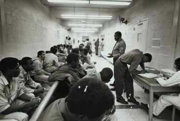 Leonard Freed, Rows of seated inmates at Tombs Prison, NYC, 1972