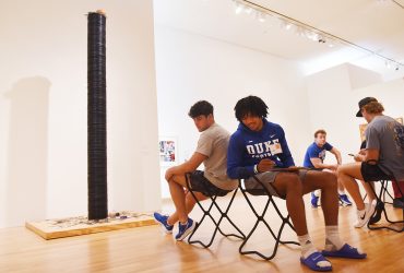 Duke student football players participate in the Back to Back Drawing activity